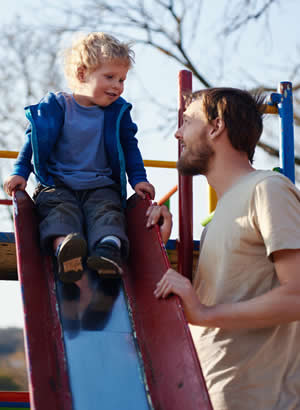 father with son on slide