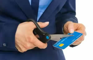 Man cutting up a credit card so he can't be tempted to use it