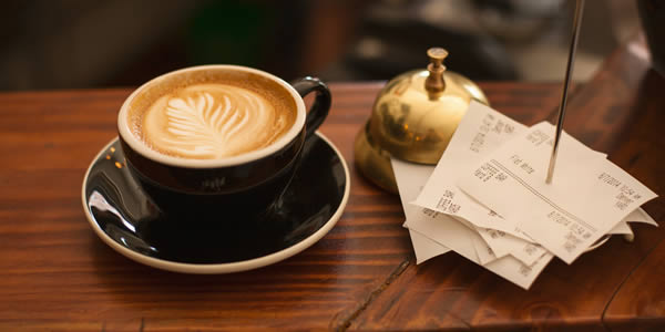 Cup of coffee in a cafe with bils