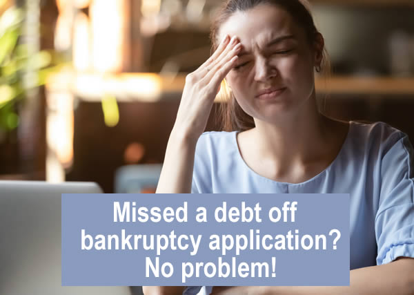 Woman sitting at her laptop realises she forgot to include a debt ion her bankruptcy application for. But this isn't a problem!