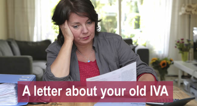Woman looking at a letter from ClearDebt trying to collect PPI from her IVA which ended years ago