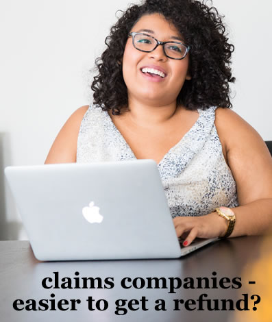 happy woman looking at lapton - is it easier to get a refund using a claims company?