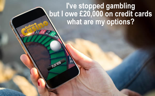 Woman playing a casino game on her mobile - has stopped gambling but owes £20,000 on credit card debt
