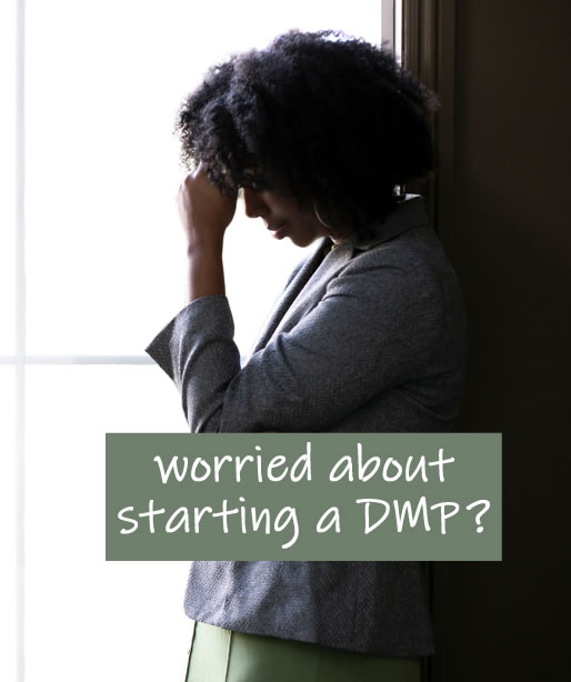 Woman atraing put of the window worried about debts. Should she start a debt management plan (DMP)?