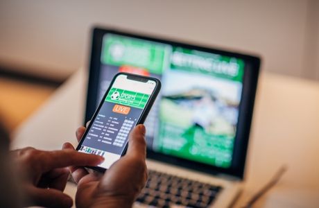 man placing a bet on a mobile