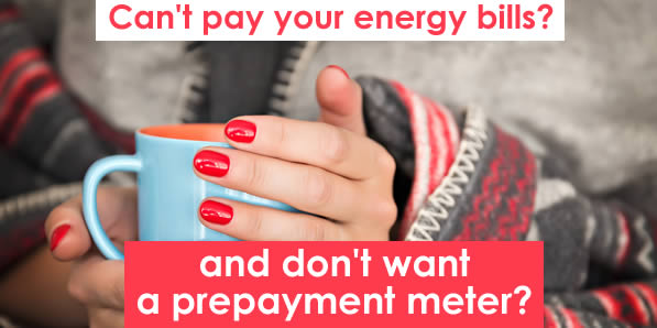 Woman wrapped up in layers and trying to keep warm with a cup of chocolate - what can you do if you can't pay your energy bills and don't want a prepayment meter fitted? 
